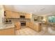 Well-lit kitchen with granite countertops, stainless steel appliances, and light wood cabinetry at 626 46Th St, Sarasota, FL 34234