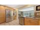 Well-equipped kitchen with a stainless steel refrigerator, ample counter space, and a pool view at 626 46Th St, Sarasota, FL 34234