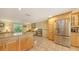 Open kitchen features a stainless steel refrigerator, ample counter space, and tile flooring at 626 46Th St, Sarasota, FL 34234