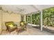 Relaxing screened-in patio with comfortable seating and views of the tropical greenery at 626 46Th St, Sarasota, FL 34234