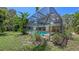 Lush tropical landscaping surrounds this screened in pool and backyard oasis at 626 46Th St, Sarasota, FL 34234