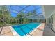 Spacious screened-in pool offering a refreshing escape and picturesque backyard views at 626 46Th St, Sarasota, FL 34234