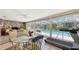 Sunroom with a dining table, exercise equipment, and sliding doors to the screened pool at 626 46Th St, Sarasota, FL 34234
