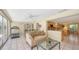 Cozy sunroom with a sofa, exercise equipment and view to the kitchen area at 626 46Th St, Sarasota, FL 34234