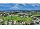 Stunning aerial view of the community surrounded by lush greenery, serene lakes, and the ocean at 718 White Pine Tree Rd # 80, Venice, FL 34285