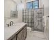 Modern bathroom featuring a stylish glass enclosed shower with hexagon tile accents and a marble look at 718 White Pine Tree Rd # 80, Venice, FL 34285