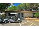 Exterior of the Bird Bay Golf Club, featuring golf carts and building facade at 718 White Pine Tree Rd # 80, Venice, FL 34285
