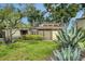 Charming single-story home featuring a well-maintained lawn and native Florida landscaping at 718 White Pine Tree Rd # 80, Venice, FL 34285
