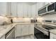 Well-equipped kitchen featuring modern appliances, granite countertops, and ample cabinet space at 718 White Pine Tree Rd # 80, Venice, FL 34285