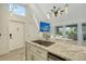 Elegant kitchen with updated fixtures and granite countertops, seamlessly connected to the living area at 718 White Pine Tree Rd # 80, Venice, FL 34285