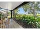 Inviting lanai with tile flooring and views of lush landscaping and blue sky at 718 White Pine Tree Rd # 80, Venice, FL 34285