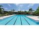 Outdoor pool with swimming lanes and lounge chairs, surrounded by lush landscaping and palm trees at 718 White Pine Tree Rd # 80, Venice, FL 34285