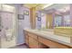 Well-lit bathroom featuring a vanity with sink, ample storage, and an enclosed shower at 7214 Cloister Dr # 7214, Sarasota, FL 34231