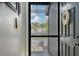 Front door leading to wood balcony with flower pot and view of the community at 7214 Cloister Dr # 7214, Sarasota, FL 34231