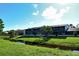Exterior building overlooking a waterway with grassy banks at 7214 Cloister Dr # 7214, Sarasota, FL 34231