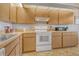Functional kitchen with ample cabinetry, countertop space, and modern white appliances at 7214 Cloister Dr # 7214, Sarasota, FL 34231