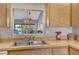 Kitchen view and a view to the dining area with a window and double sink at 7214 Cloister Dr # 7214, Sarasota, FL 34231