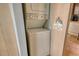 A stackable washer and dryer with a sign that says 