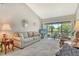 Bright living room with sliding glass doors that offer community views and a vaulted ceiling at 7214 Cloister Dr # 7214, Sarasota, FL 34231
