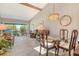 Spacious living room featuring vaulted ceiling, a glass dining table, and sliding doors to the exterior at 7214 Cloister Dr # 7214, Sarasota, FL 34231