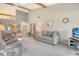 An open-plan living room and dining area featuring bright natural light and a vaulted ceiling at 7214 Cloister Dr # 7214, Sarasota, FL 34231