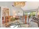 Open concept living and dining area featuring vaulted ceiling and sliding doors to the balcony at 7214 Cloister Dr # 7214, Sarasota, FL 34231