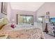 Serene bedroom with a leaf-patterned bedspread and a door to the outside at 7214 Cloister Dr # 7214, Sarasota, FL 34231