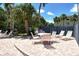 Relaxing patio area featuring a table and chairs, perfect for outdoor dining amidst lush greenery at 7214 Cloister Dr # 7214, Sarasota, FL 34231
