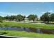 Scenic view of a waterway with mature trees on a sunny day at 7214 Cloister Dr # 7214, Sarasota, FL 34231