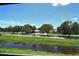 Tranquil waterway view with mature trees and a serene sky at 7214 Cloister Dr # 7214, Sarasota, FL 34231