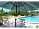 Community pool with comfortable seating and lush landscaping offers a relaxing atmosphere at 7214 Cloister Dr # 7214, Sarasota, FL 34231