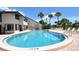 Community pool with poolside furniture and landscaped surroundings, perfect for outdoor enjoyment at 7214 Cloister Dr # 7214, Sarasota, FL 34231