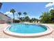 Enjoy the pool with comfortable lounge seating and lush, green landscaping at 7214 Cloister Dr # 7214, Sarasota, FL 34231
