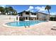 Community pool with ample seating and lush landscaping, ideal for relaxation and recreation at 7214 Cloister Dr # 7214, Sarasota, FL 34231