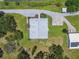 Overhead shot of a home with a metal roof, landscaped yard, and driveway, set in a green, wooded area at 7264 Spencer Parrish Rd, Parrish, FL 34219