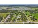 Wide aerial shot capturing numerous homes, serene ponds, and sprawling green expanses at 7264 Spencer Parrish Rd, Parrish, FL 34219
