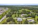 Expansive aerial view of a property featuring a charming home with a metal roof surrounded by lush greenery at 7264 Spencer Parrish Rd, Parrish, FL 34219