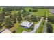 Scenic aerial view showcasing a home with a metal roof, a long driveway, and verdant surroundings at 7264 Spencer Parrish Rd, Parrish, FL 34219