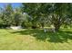 Secluded backyard with hammock, bench, and mature shade trees create a relaxing and private oasis at 7264 Spencer Parrish Rd, Parrish, FL 34219
