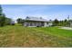 Exterior view of home with large, grassy backyard, providing plenty of space for outdoor activities and recreation at 7264 Spencer Parrish Rd, Parrish, FL 34219