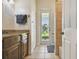 Bright bathroom with a granite countertop vanity and a glass door leading to the backyard at 7264 Spencer Parrish Rd, Parrish, FL 34219