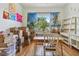 Bedroom with light green walls, hardwood floors, window with curtains, desk, chair and shelving at 7264 Spencer Parrish Rd, Parrish, FL 34219