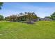 Exterior of home with lush landscaping, large front yard, and welcoming front porch at 7264 Spencer Parrish Rd, Parrish, FL 34219