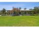 A charming single-story home with a metal roof and inviting front porch, surrounded by a well-manicured lawn at 7264 Spencer Parrish Rd, Parrish, FL 34219