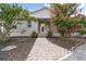 Charming front entrance with a brick walkway, small porch, and well-maintained landscaping creating a welcoming feel at 7264 Spencer Parrish Rd, Parrish, FL 34219