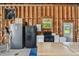 A well-lit garage with functional appliances, workspace and rustic, wooden walls at 7264 Spencer Parrish Rd, Parrish, FL 34219