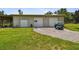 Large garage with multiple bays and a golf cart parked outside at 7264 Spencer Parrish Rd, Parrish, FL 34219