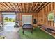 Interior of garage with a pool table, bench, and open garage door at 7264 Spencer Parrish Rd, Parrish, FL 34219
