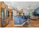 Spacious kitchen featuring wooden cabinets, granite countertops, stainless steel appliances, and a breakfast bar at 7264 Spencer Parrish Rd, Parrish, FL 34219