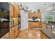 Kitchen featuring wooden cabinets, stainless steel oven, and a door leading to a pantry at 7264 Spencer Parrish Rd, Parrish, FL 34219